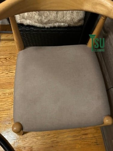 The same dining chair seat after cleaning, with an even light finish
