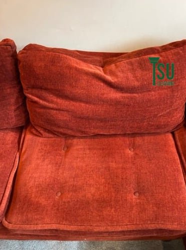 The same rust-colored sofa after cleaning, with the pile lifted and the color restored